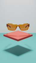 Sculptural sunglasses in electric amber